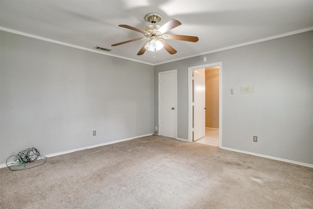 unfurnished room featuring light carpet, visible vents, baseboards, a ceiling fan, and ornamental molding