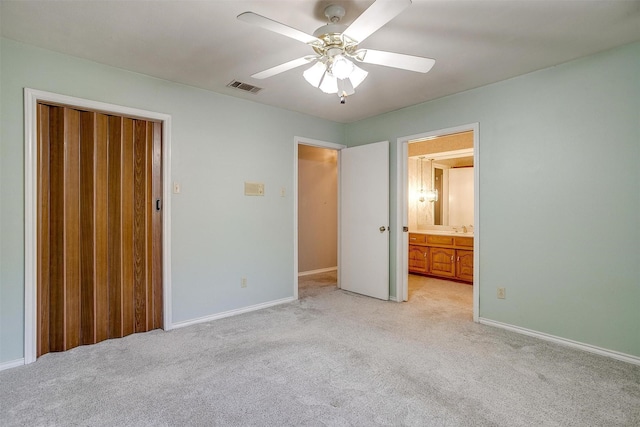 unfurnished bedroom featuring light colored carpet, visible vents, and baseboards