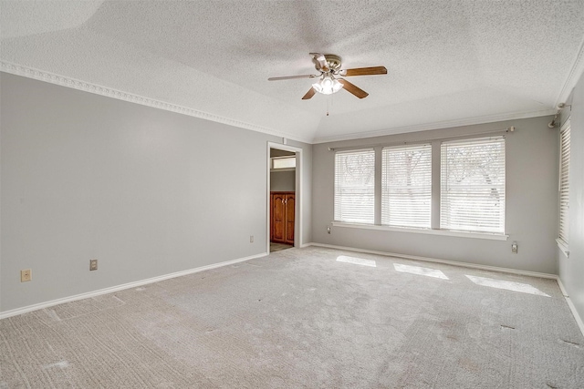 spare room with baseboards, ceiling fan, light colored carpet, and crown molding