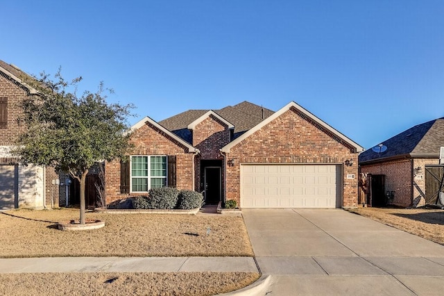 ranch-style house with concrete driveway, brick siding, and an attached garage