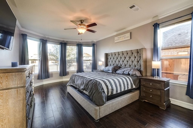 bedroom featuring ornamental molding, dark wood finished floors, visible vents, and baseboards