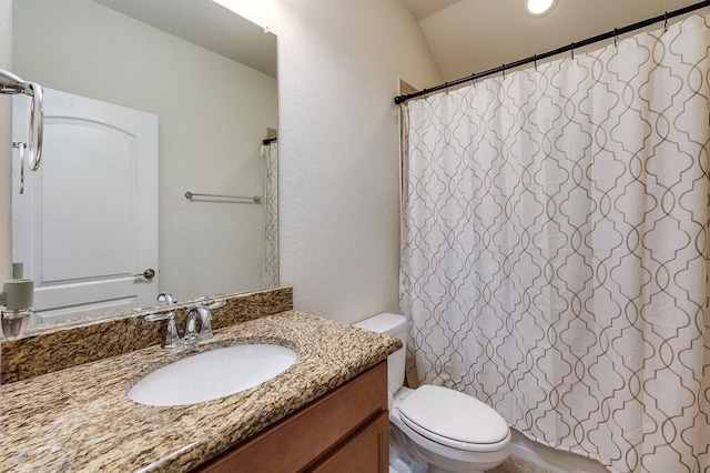 bathroom with toilet, curtained shower, and vanity