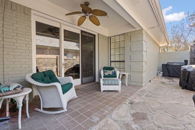 view of patio featuring visible vents, fence, and ceiling fan