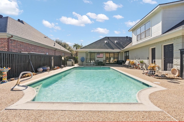 view of swimming pool with a patio, fence, and a fenced in pool