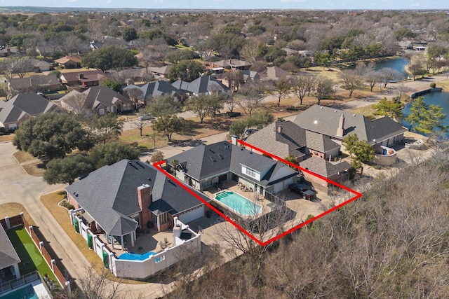 drone / aerial view featuring a residential view and a water view