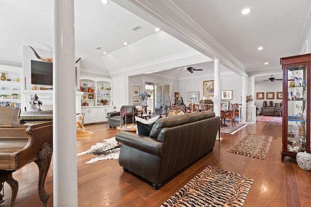 living room featuring built in shelves, a ceiling fan, visible vents, and wood finished floors