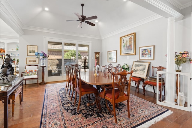 dining space featuring ceiling fan, built in shelves, crown molding, wood finished floors, and ornate columns