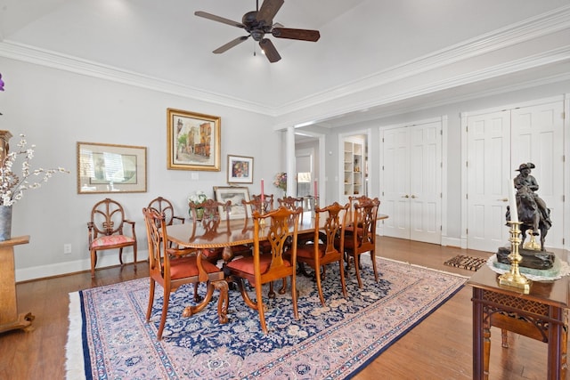 dining room with ceiling fan, ornamental molding, wood finished floors, and baseboards