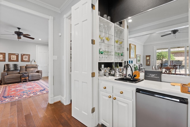 kitchen with ornamental molding, light countertops, dishwashing machine, and white cabinetry