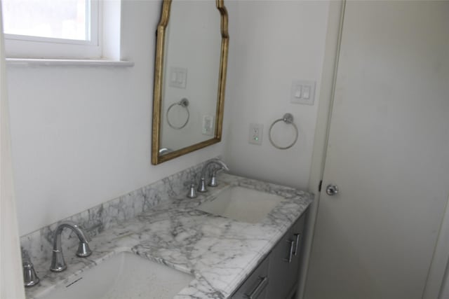 bathroom featuring a sink and double vanity