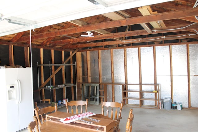 garage featuring white fridge with ice dispenser