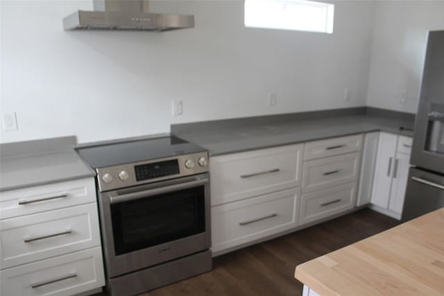 kitchen with appliances with stainless steel finishes, dark wood-type flooring, white cabinetry, and under cabinet range hood