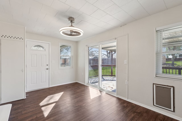 foyer entrance featuring baseboards and wood finished floors