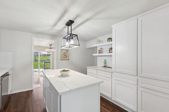 kitchen featuring light stone counters, a center island, dark wood finished floors, open shelves, and dishwasher