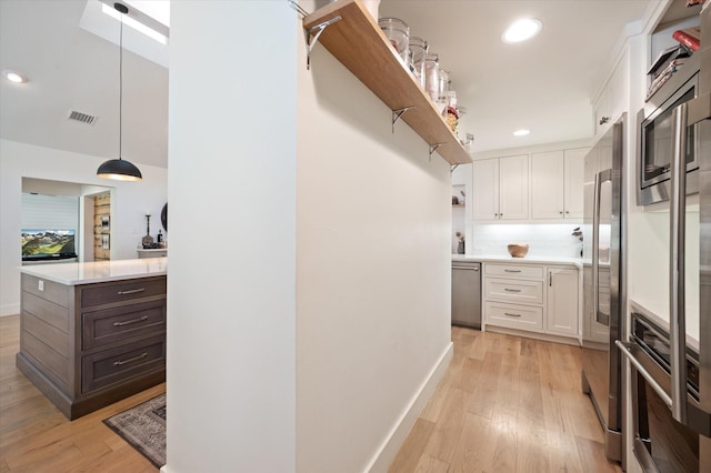 kitchen featuring light countertops, dark brown cabinets, open shelves, and white cabinetry