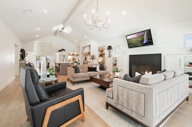 living area with light wood-style floors, a notable chandelier, visible vents, and beam ceiling