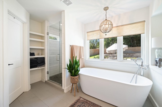 full bath with a freestanding bath, a wealth of natural light, a stall shower, and visible vents