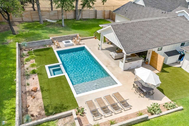 view of swimming pool with an outbuilding, a patio area, area for grilling, and a fenced backyard