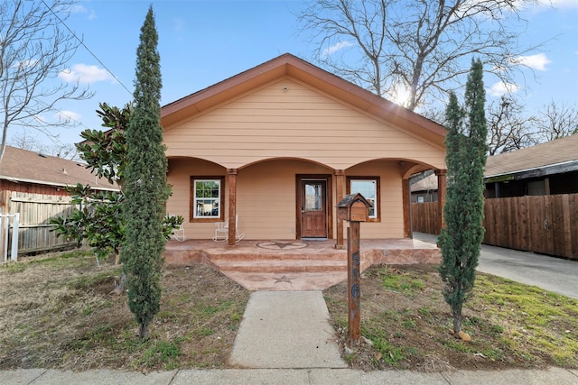 view of front facade with a porch and fence