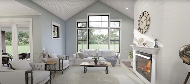 living area with a warm lit fireplace and high vaulted ceiling