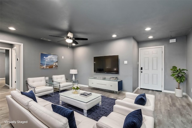 living room with ceiling fan, baseboards, light wood-style flooring, and recessed lighting