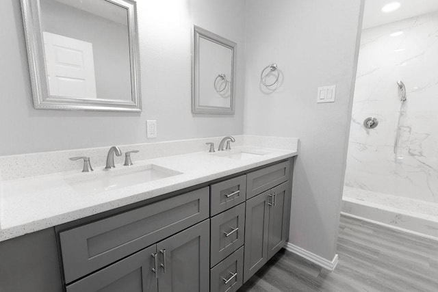 3321 Old Hickory Trl, Forest Hill, TX 76140 - bathroom with double vanity, a marble finish shower, wood finished floors, and baseboards