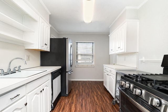 kitchen with appliances with stainless steel finishes, white cabinetry, and a sink