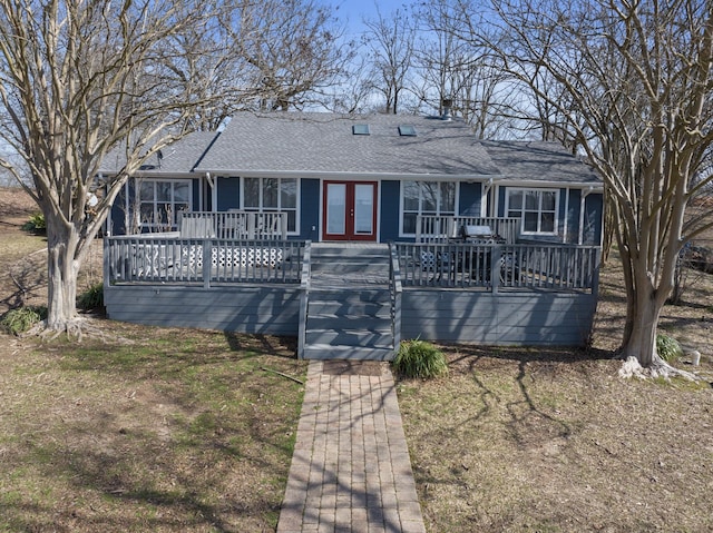 ranch-style house with a shingled roof, french doors, and a wooden deck