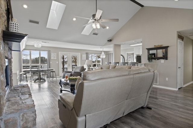 living area with dark wood-style flooring, visible vents, french doors, and a healthy amount of sunlight