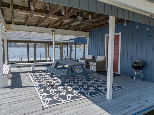 deck featuring a water view and a ceiling fan