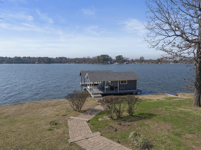 dock area featuring a lawn and a water view