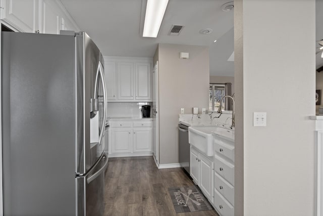 kitchen featuring dark wood finished floors, visible vents, backsplash, appliances with stainless steel finishes, and white cabinets