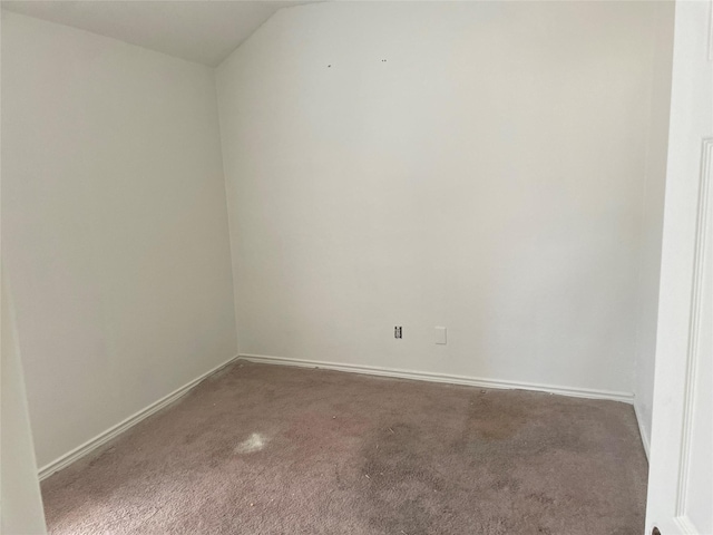 carpeted spare room with baseboards