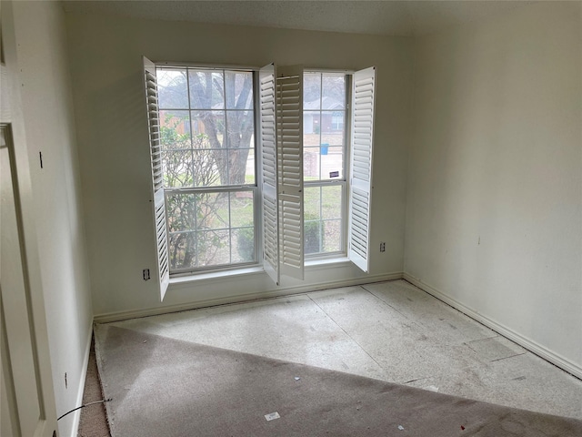 empty room featuring baseboards