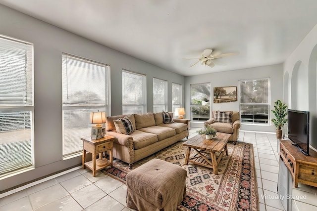 interior space with arched walkways and ceiling fan