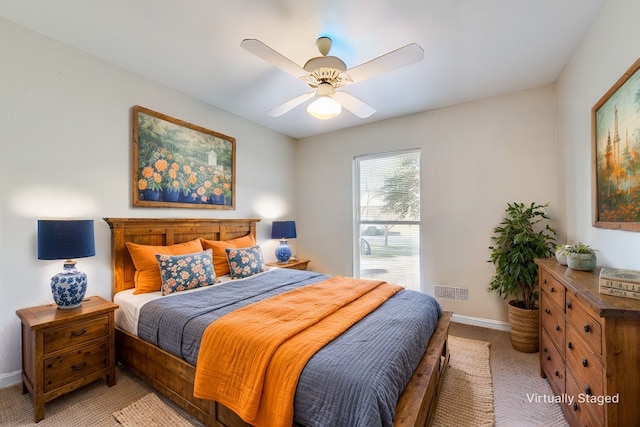 carpeted bedroom with a ceiling fan and baseboards