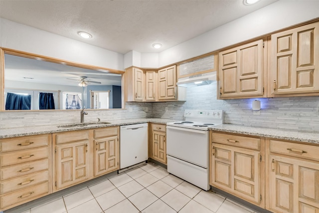 kitchen featuring light brown cabinets, white appliances, a sink, and under cabinet range hood