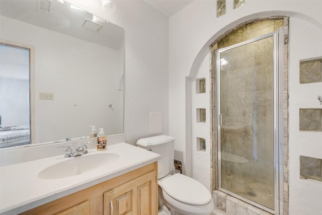 ensuite bathroom with a stall shower, visible vents, toilet, ensuite bath, and vanity