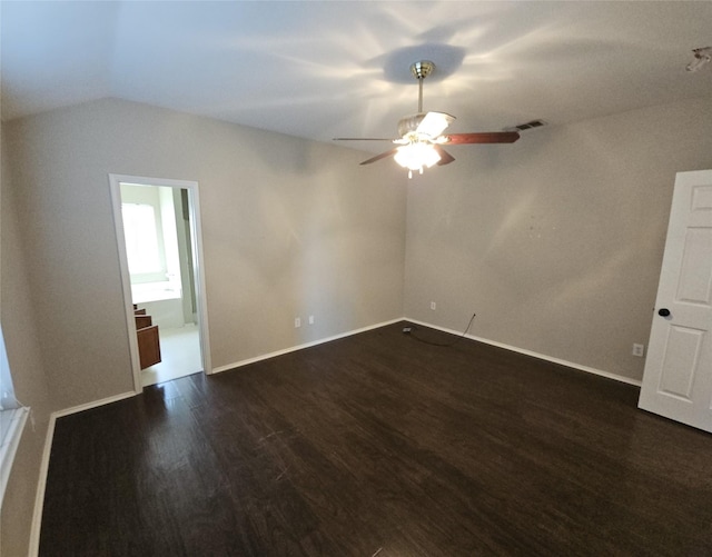 interior space featuring lofted ceiling, visible vents, dark wood-type flooring, ceiling fan, and baseboards