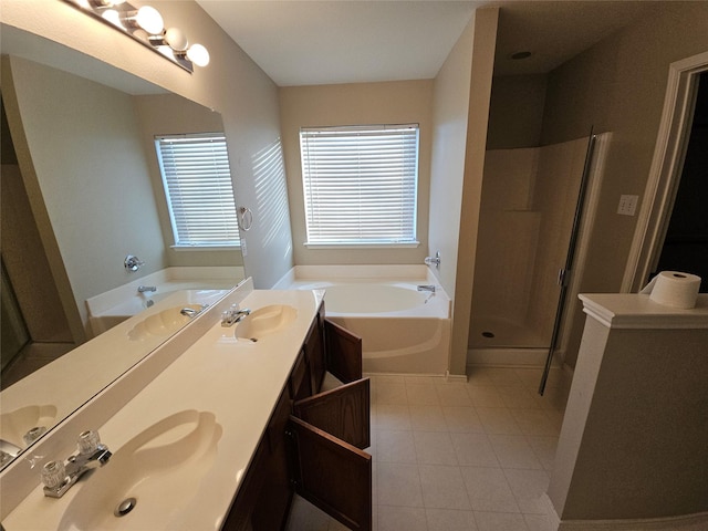 full bath featuring a sink, double vanity, a garden tub, and a shower stall