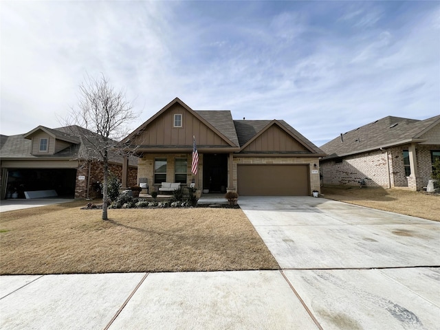 craftsman-style house with a garage, driveway, brick siding, and board and batten siding