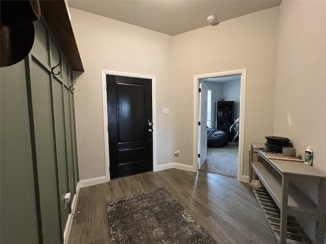 foyer with baseboards and dark wood finished floors