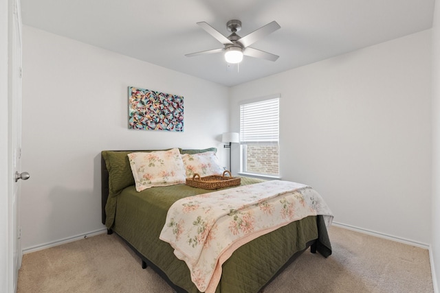 bedroom with baseboards, ceiling fan, and light colored carpet