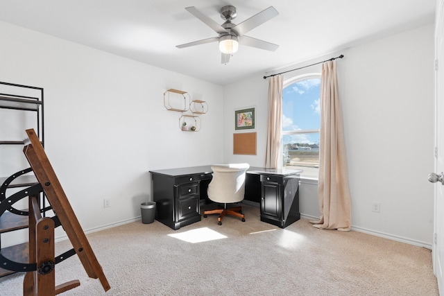 office area with light carpet, ceiling fan, and baseboards