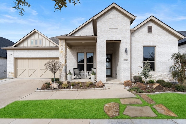 view of front of home with concrete driveway, an attached garage, a porch, board and batten siding, and brick siding