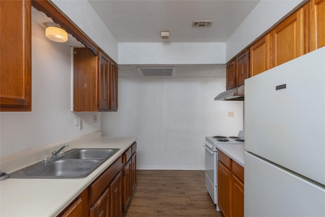 kitchen featuring brown cabinetry, white appliances, and light countertops