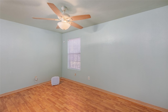 unfurnished room featuring a ceiling fan, light wood-type flooring, and baseboards