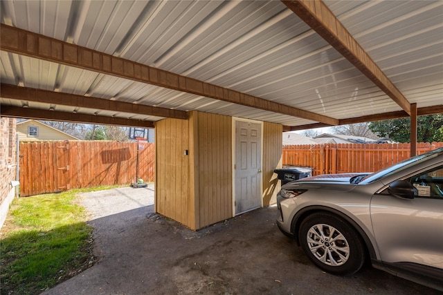 exterior space with a carport and fence