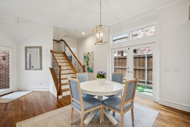 dining space featuring light wood-style floors, stairway, and a healthy amount of sunlight