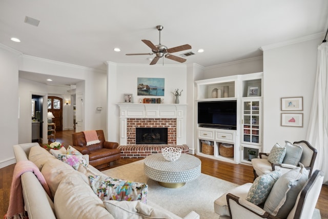 living room with ceiling fan, recessed lighting, dark wood-type flooring, visible vents, and a brick fireplace